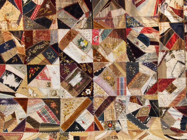 Crazy quilt featuring velvet, silk, embroidery and hand-painted flowers, given to Mr. & Mrs. A.A. Methner of Little Falls, MN, by Mrs. Louise Evans of Fargo, ND. The quilt, made in 1893, is believed to have been made by a member of Mrs. Evans' family. MCHS Collections #1975.40.1.