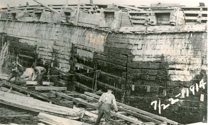 http://www.morrisoncountyhistory.org/museumpics/damrepair75.jpg This photo shows the structure of the third Little Falls dam. Note that it is made of wood. The photo is labeled to indicate that the third dam is being repaired; however, from the date on the photo, July 22, 1914, the men shown could be preparing for the construction of the fourth dam.