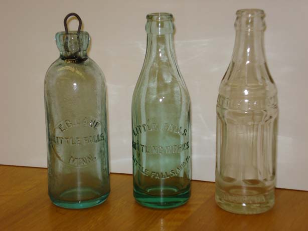 http://www.morrisoncountyhistory.org/museumpics/lanebottle3s.jpg Bottles from the Little Falls Bottling Works in the collections of MCHS. The left one is an E. C. Lane bottle with a metal and rubber cork. It appears to be hand-blown. The others are later models. Photo by Mary Warner, August 29, 2007.