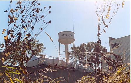 http://www.morrisoncountyhistory.org/museumpics/wtrtwr75.jpg Little Falls water tower, located on Seventh Avenue NE, next to Little Falls City Hall. Dismantled November 8, 2006, after being replaced by a larger water tower in northeast Little Falls. Photo taken from behind and below Larson Motor Service. Photo by Mary Warner, October 2003.